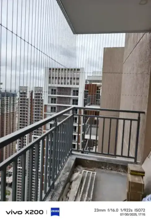 Invisible grills on high-rise balcony with Chennai skyline view