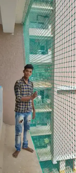 Technician demonstrating safety net installation Chennai apartment