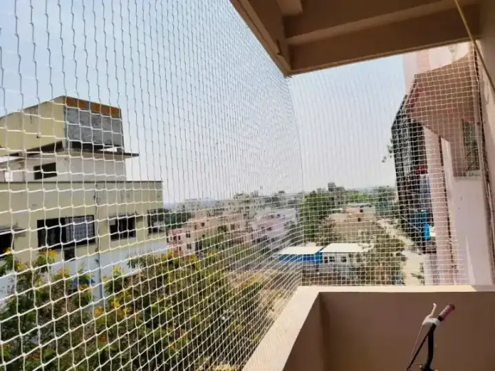 White safety net installation for high-rise apartment balcony in Anna Nagar Chennai