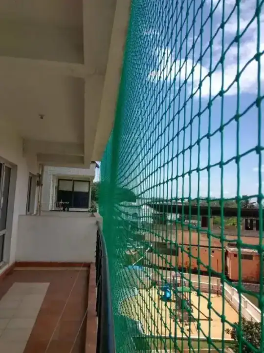 Green balcony safety net installation on Chennai apartment building